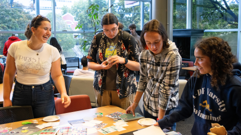 Students in the Mueller Center gathering around a table