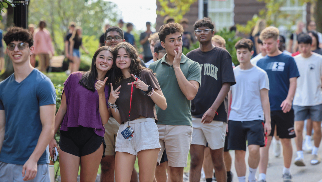 Students walking in a row having a good time.